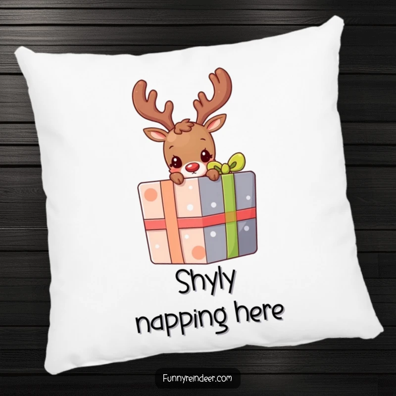 Funny pillow decorated with a shy reindeer peeking its head out from behind a large, colorful gift, adding a touch of cute mystery.
