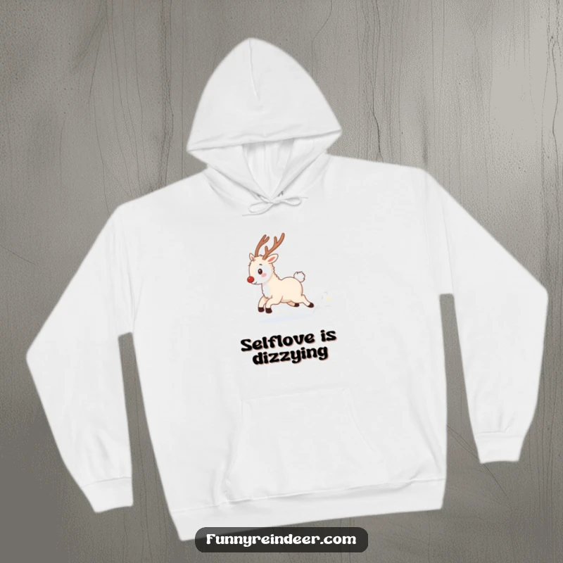 Funny hoodie graphic of a fluffy reindeer playfully engaged in chasing its twinkling tail amidst a serene, snowy winter setting.