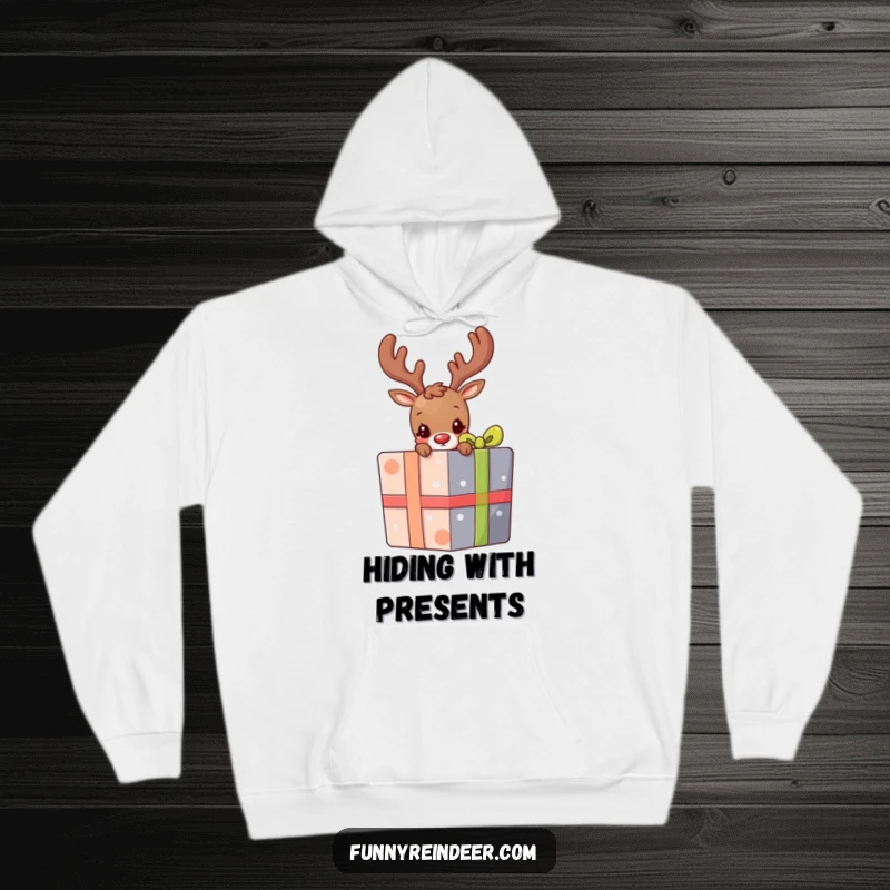 Funny hoodie depicting a shy reindeer peeking its head and antlers out from behind a large, colorful festive present.