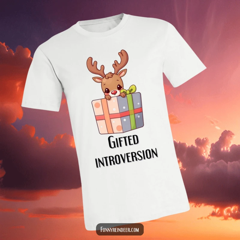 Funny t-shirt with a cute, shy reindeer cautiously peeking from behind a large, vibrantly colored holiday gift box.